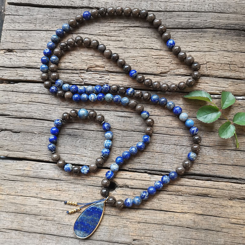 Ce puissant collier mala "confiance en soi" en Lapis Lazuli et Bronzite, lorsqu'il est porté avec intention, aide à se concentrer et à fixer des intentions positives pour soi-même qui cultivent l'amour de soi et la force de caractère.  Avec sa combinaison de couleurs audacieuses entre les pierres bleues lapis-lazuli et les accents bronzés de la bronzite, ce collier est un beau rappel de la confiance en son intuition et de la foi en ses décisions.