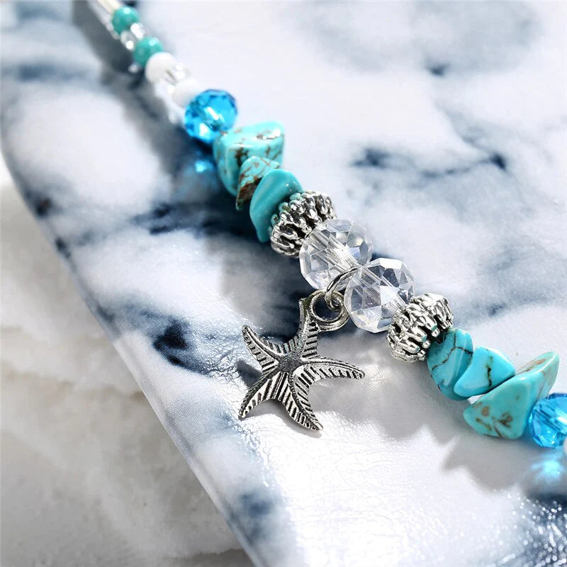 Un magnifique bracelet de cheville pour montrer votre sensualité !  Ce bracelet de cheville est le moyen idéal d'ajouter une touche de glamour et de sensualité à votre look. Il comporte des perles turquoise naturelles et d'une délicate breloques en forme d'étoile de mer, ce qui en fait une chaîne de cheville parfaite pour toute occasion spéciale.